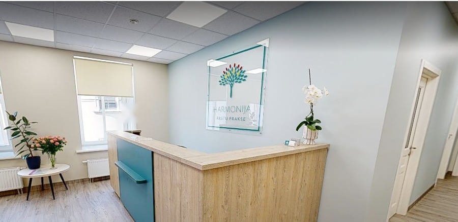 Harmonija's reception with the practice logo on the wall